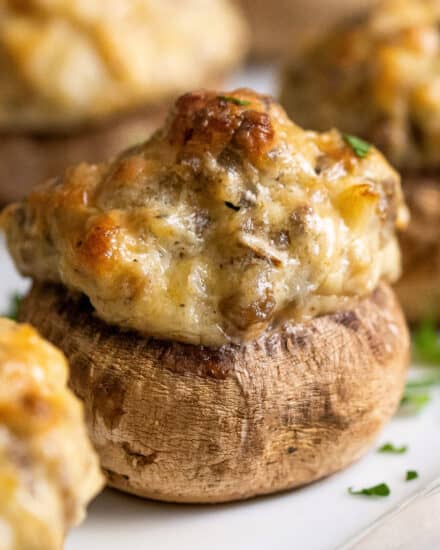 These Italian Sausage Stuffed Mushrooms are the ultimate party appetizer! Stuffed with a creamy sausage filling, then baked until deliciously golden, every bite is a flavor explosion. They can even be assembled and prepped ahead of time! #stuffedmushrooms #sausage #appetizer #fingerfood