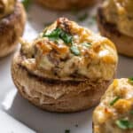 sausage stuffed mushroom on white platter