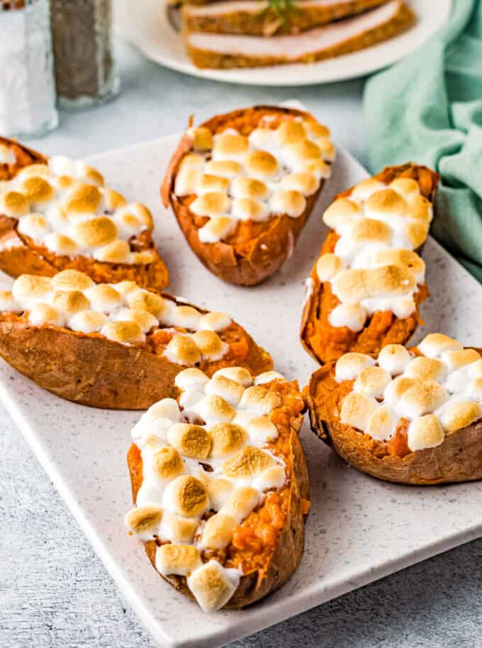 several twice baked sweet potatoes on a white platter
