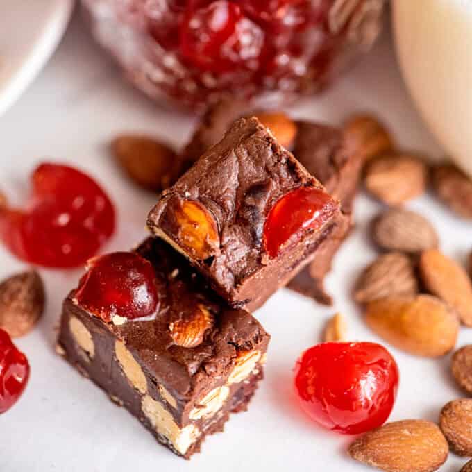 This Cherry Almond Chocolate Fudge is thick, smooth, and oh so chocolate-y, and studded with salted almonds and sweet candied cherries. Made easily with NO candy thermometer, this fool-proof fudge recipe is perfect for any holiday! #fudge #chocolate #cherry #nobakedessert