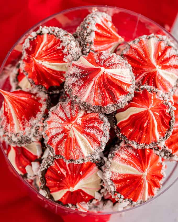 pile of peppermint meringue cookies in clear bowl