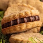 shortbread cookie sandwich cookies in tin with holiday decor