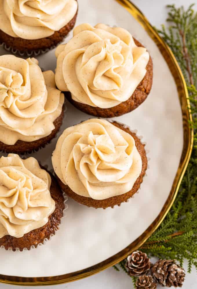 These moist and tender Gingerbread Cupcakes are packed with the rich flavor of molasses and warm holiday spices. Topped with a silky vanilla and cinnamon cream cheese frosting, these cupcakes are the perfect holiday dessert! #cupcakes #gingerbread #baking #dessert