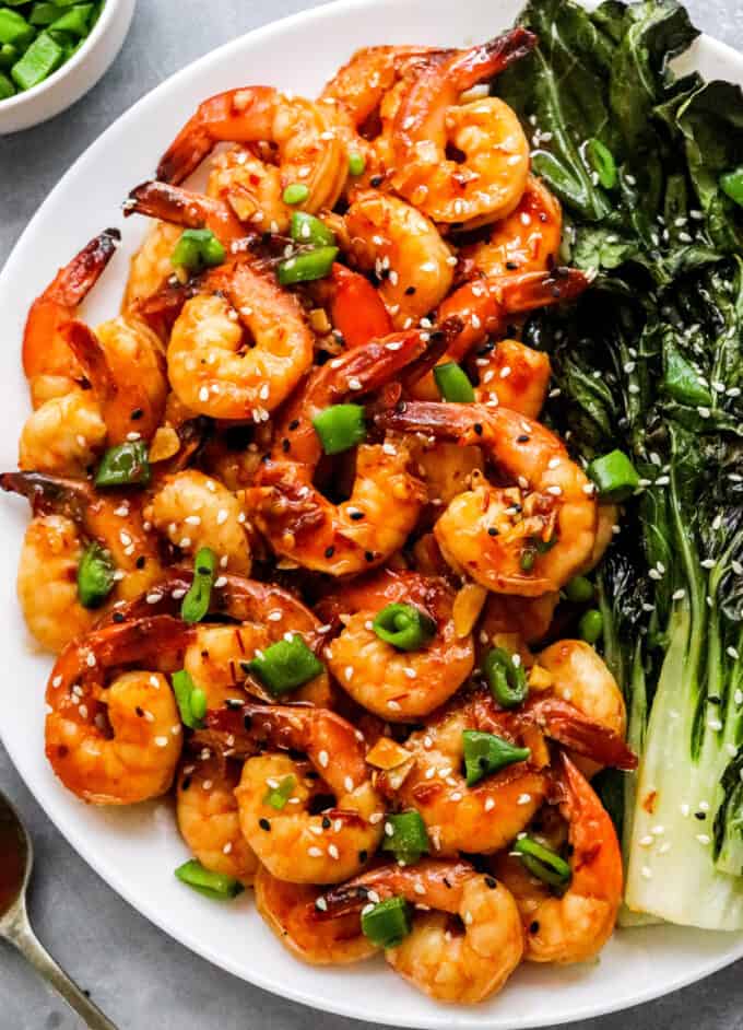 This easy sheet pan meal has shrimp and baby bok choy tossed in a mouthwatering chili garlic sauce, then cooked together on a baking sheet. Dinner is ready in 20-30 minutes, and you have way less dishes to wash! #shrimp #sheetpan #bokchoy