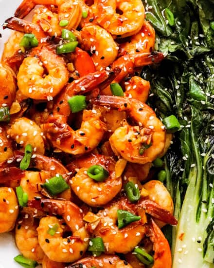 This easy sheet pan meal has shrimp and baby bok choy tossed in a mouthwatering chili garlic sauce, then cooked together on a baking sheet. Dinner is ready in 20-30 minutes, and you have way less dishes to wash! #shrimp #sheetpan #bokchoy