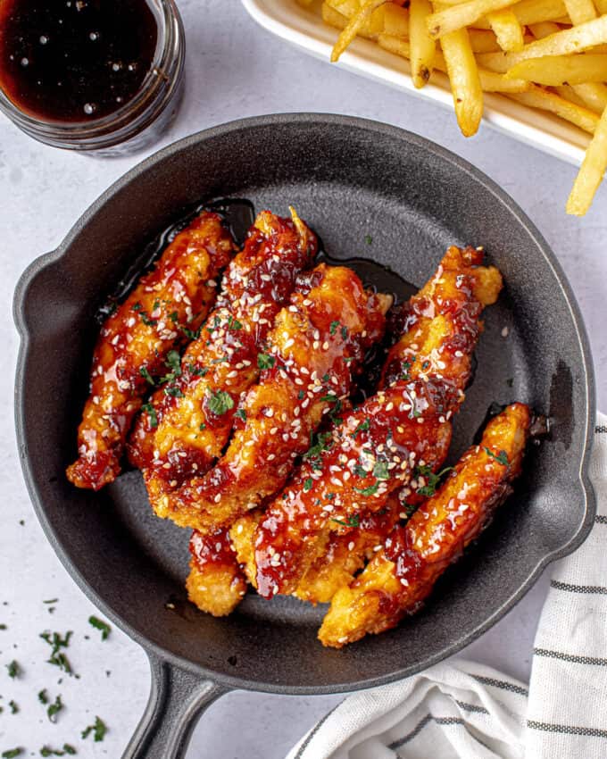 sesame jack chicken strips served in cast iron skillet