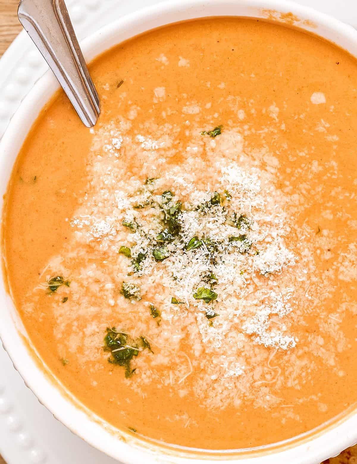 This bold and ultra flavorful Creamy Tomato Basil Soup is out of this world amazing! It uses a lot of pantry staple ingredients, and can easily be made in the slow cooker, Instant Pot, or right on your stovetop. You won't want canned tomato soup ever again! #tomatosoup #creamytomato #soup