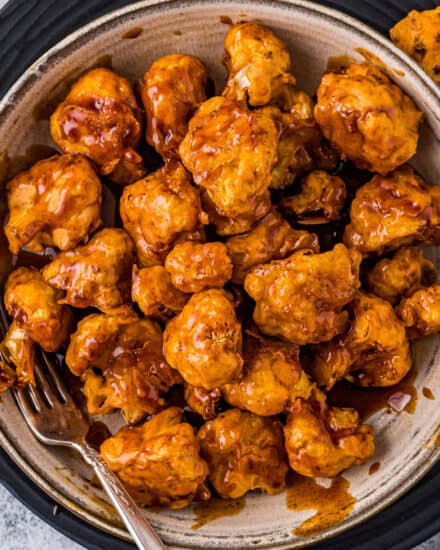 These Honey Chipotle Air Fryer Cauliflower Bites are perfectly crispy, hearty, made easily in the air fryer, and coated in the most mouthwatering honey chipotle sauce! This recipe is a copycat of Chili's honey chipotle chicken crispers, but made vegetarian by using cauliflower instead of chicken. #cauliflower #airfryer #copycat #chilis