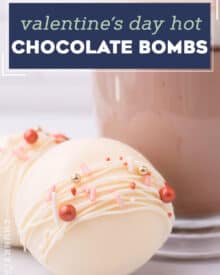 These Hot Chocolate Bombs are perfect for Valentine's Day, or can be decorated for any holiday! Beautiful spheres of white chocolate are filled with hot cocoa mix and marshmallows... just add one to a mug and top with warm milk for the perfect cold weather drink! #hotchocolate #bombs #valentinesday