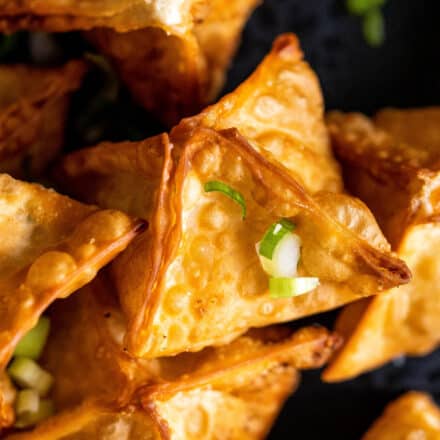 fried crab rangoon garnished with green onions