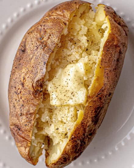 Baked Potatoes made in the air fryer are absolutely the best! Potatoes are rubbed with a garlic herb salt rub, then cooked to perfection in the air fryer, without having to heat up your whole house with the oven. Ultra crispy and flavorful skins and fluffy creamy insides... ready to eat!