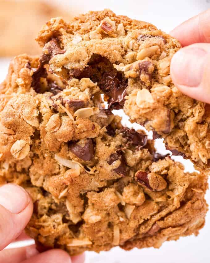 breaking apart a cookie to see the melted chocolate chips inside