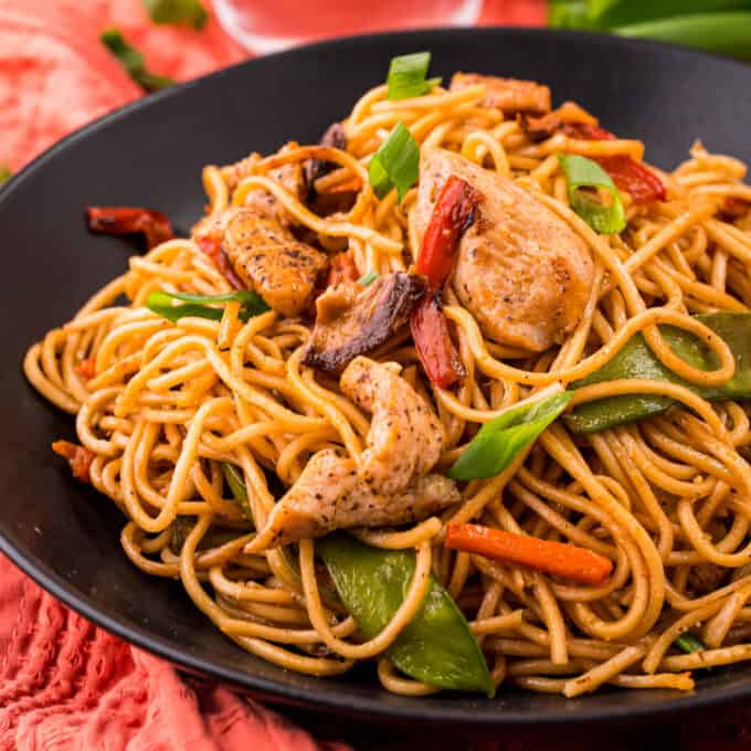 Better than takeout, this Chicken Lo Mein recipe comes together quickly, in one skillet, and is full of juicy chicken, tender lo mein noodles, and crisp tender veggies, all coated in a silky savory sauce!