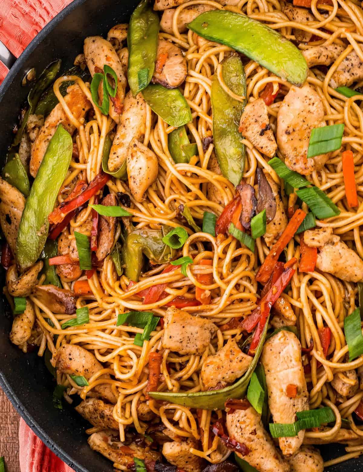 Better than takeout, this Chicken Lo Mein recipe comes together quickly, in one skillet, and is full of juicy chicken, tender lo mein noodles, and crisp tender veggies, all coated in a silky savory sauce!