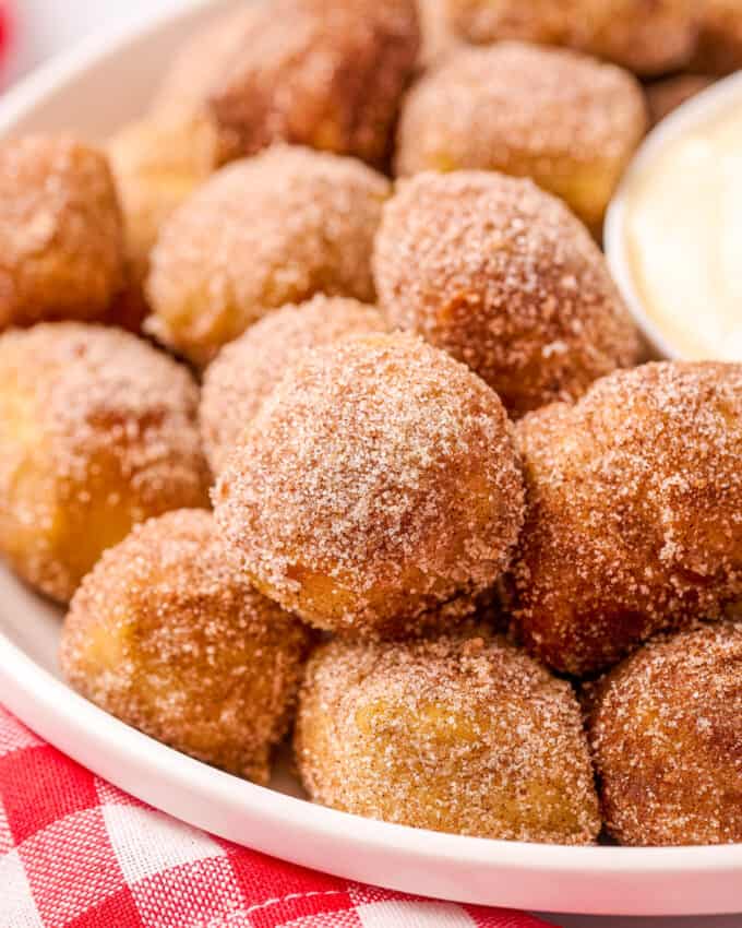 These Cinnamon Sugar Soft Pretzel Bites are soft and chewy inside, with a crunchy, crackly exterior, dipped in butter and rolled in a mixture of cinnamon and sugar! Perfectly buttery and sweet, and amazing with a sweet cream cheese dip!