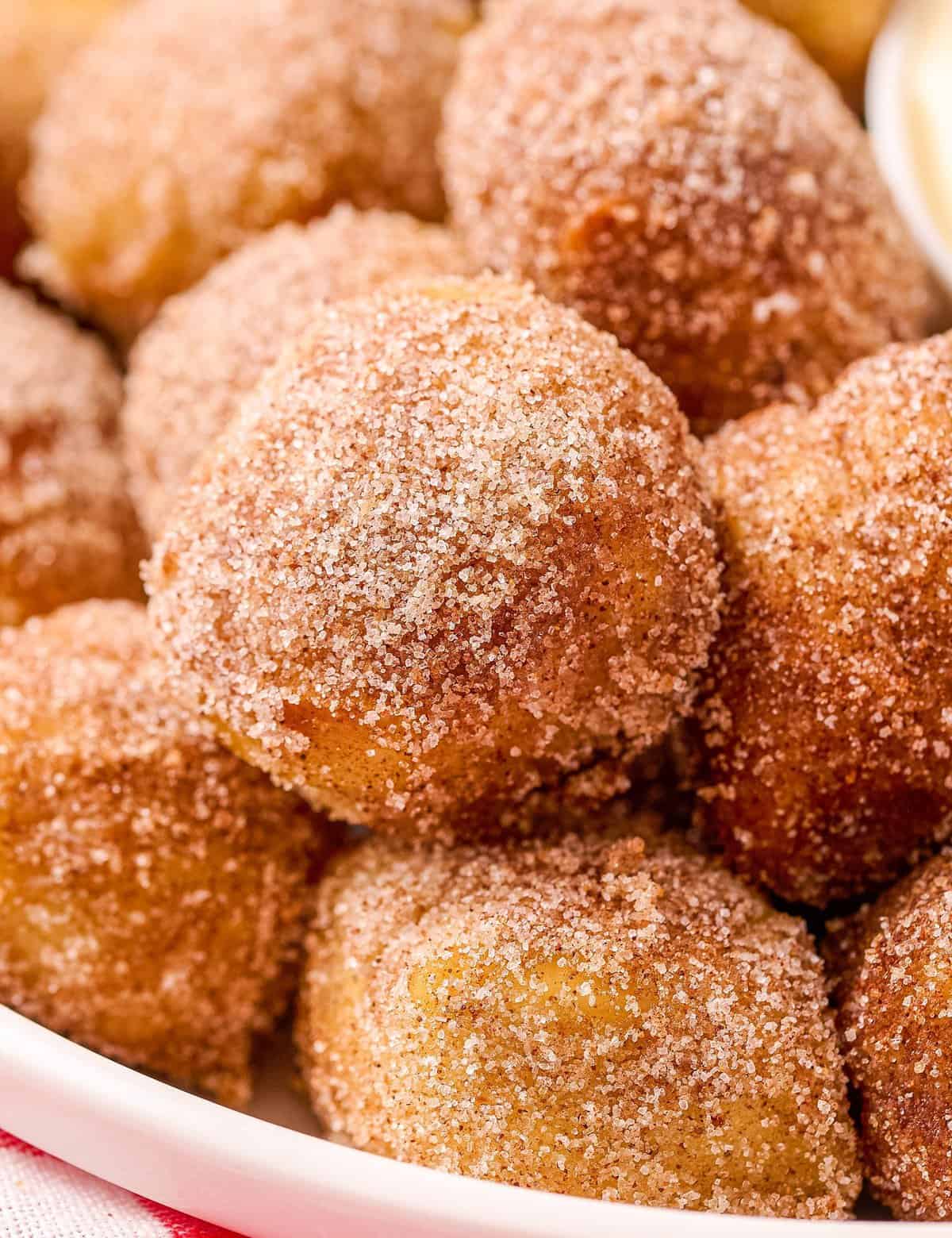 These Cinnamon Sugar Soft Pretzel Bites are soft and chewy inside, with a crunchy, crackly exterior, dipped in butter and rolled in a mixture of cinnamon and sugar! Perfectly buttery and sweet, and amazing with a sweet cream cheese dip!