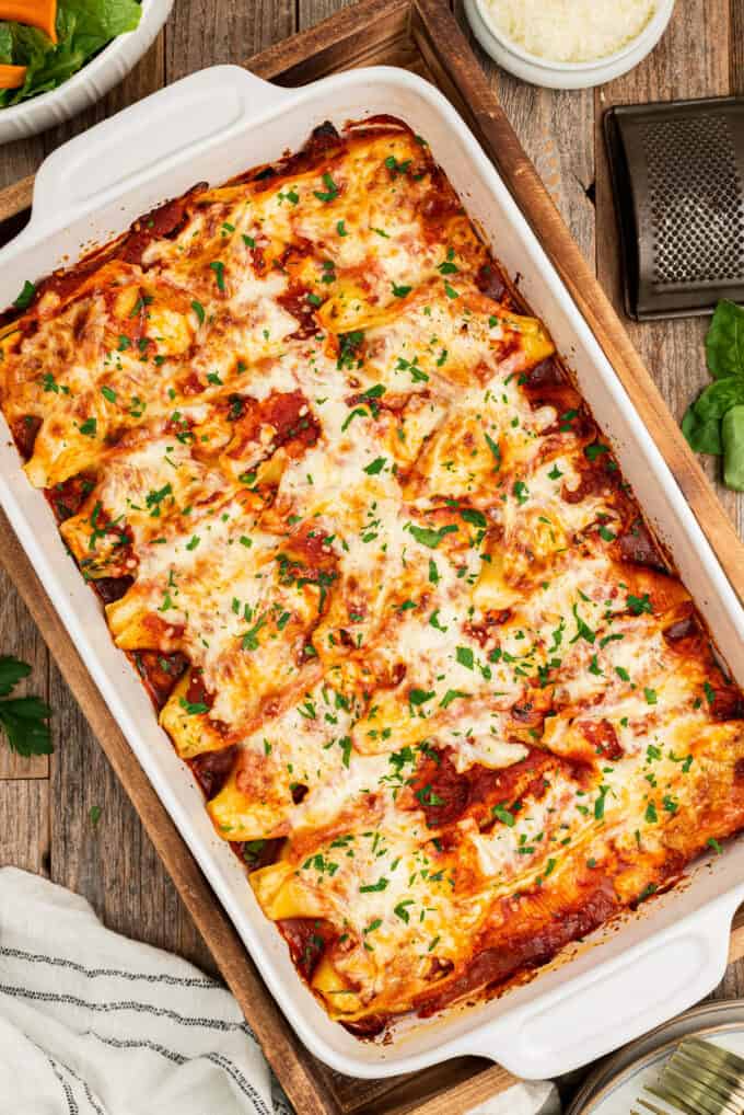 baking dish with stuffed shells on wooden table
