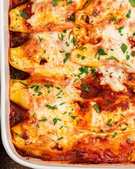 Pasta shells are stuffed with a cheesy ricotta, spinach and garlic filling, then smothered in marinara sauce and mozzarella cheese and baked until bubbly and golden brown! Perfect as a make-ahead dinner idea, and it's freezer-friendly as well.