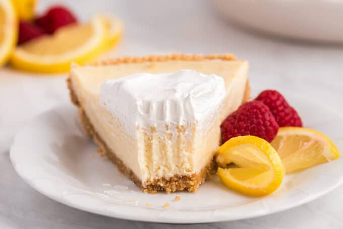 slice of lemon pie with a forkful taken out