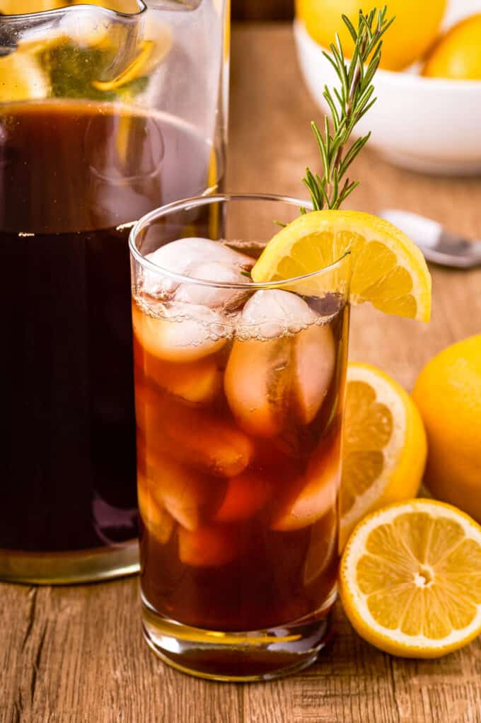 tall glass of iced sweet tea with lemon and rosemary