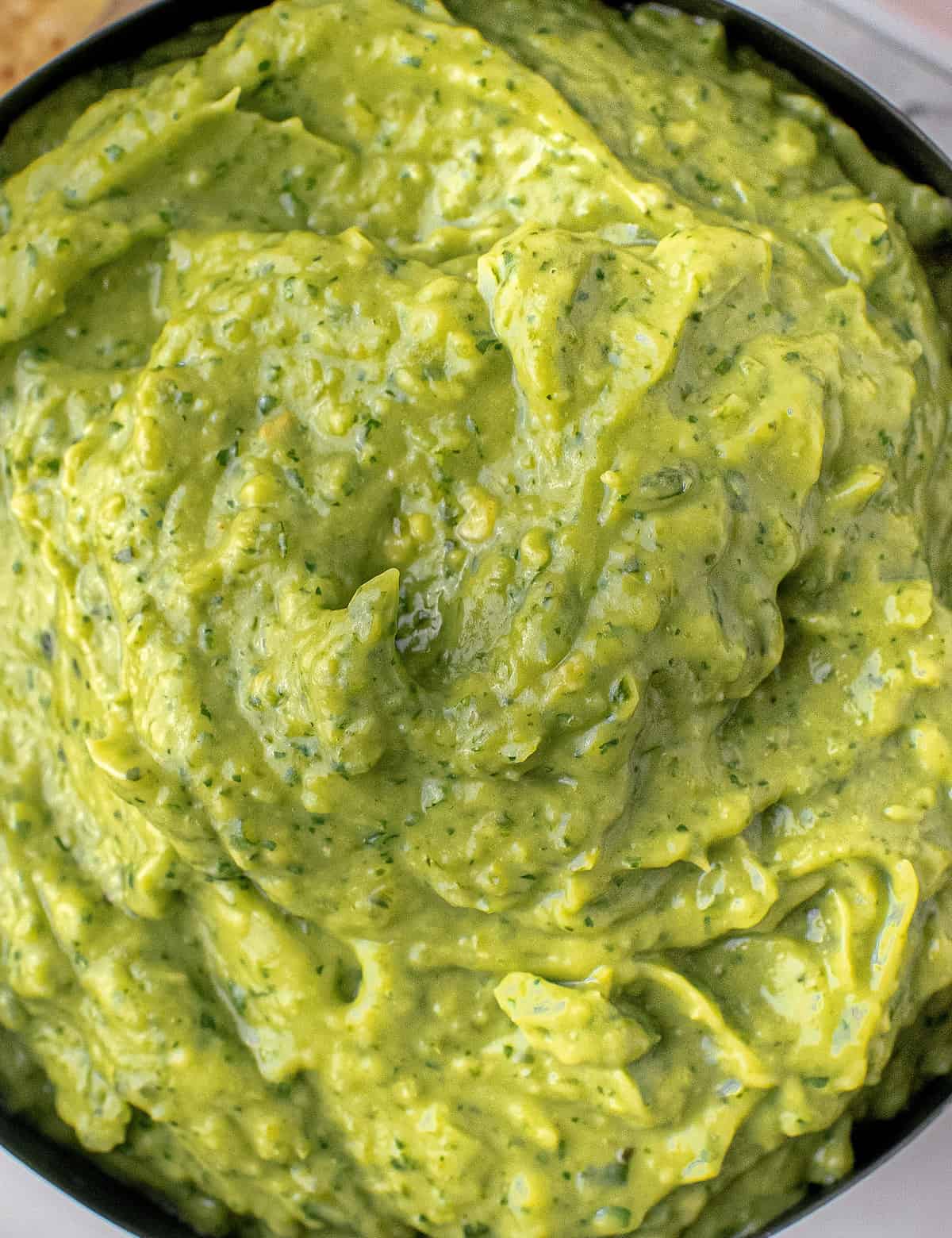 This easy avocado dip recipe is made with simple ingredients common in tex-mex foods. Smoky, spicy, and oh so creamy, this dip is great with chips, on tacos, burritos, and more!