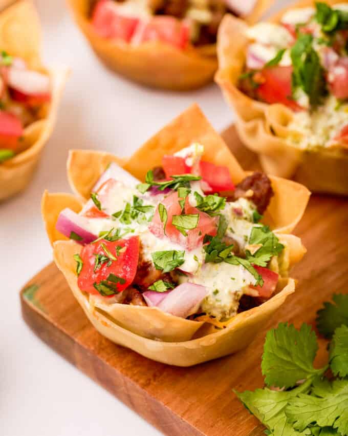 beef taco cups on wooden cutting board