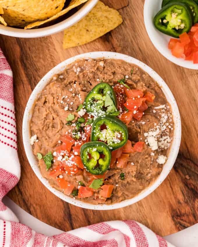 party table with bowl of refried beans and chips