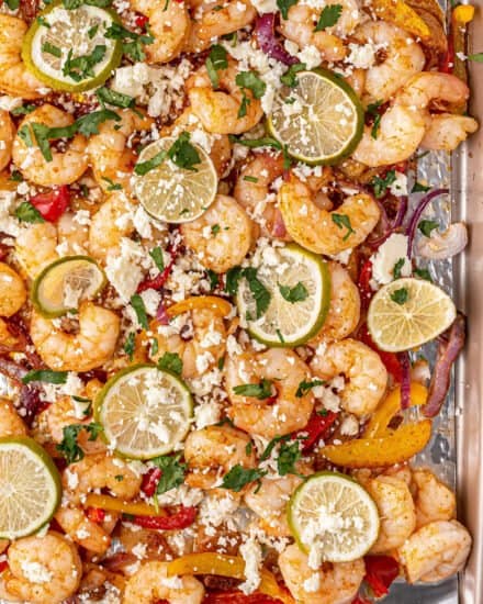Juicy shrimp and tender onions and peppers, tossed in a mouthwatering honey lime fajita marinade, all baked on one sheet pan. The perfect tex-mex weeknight dinner idea!