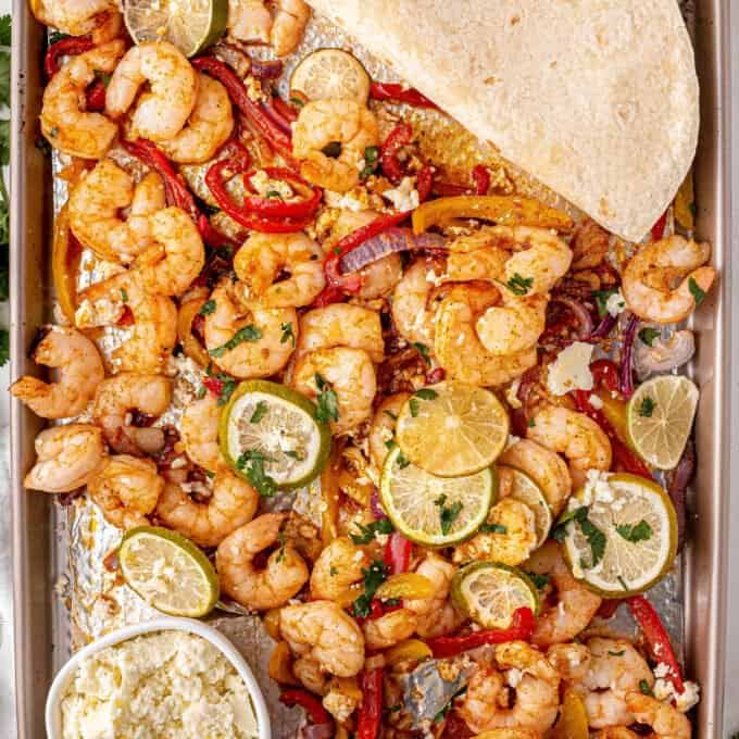 shrimp fajitas on sheet pan with tortillas