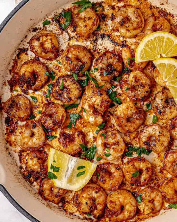 blackened shrimp in skillet with lemon slices