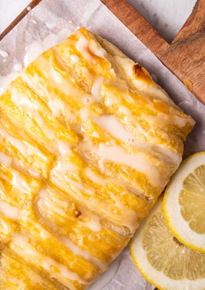 braided cream cheese danish on cutting board with parchment paper