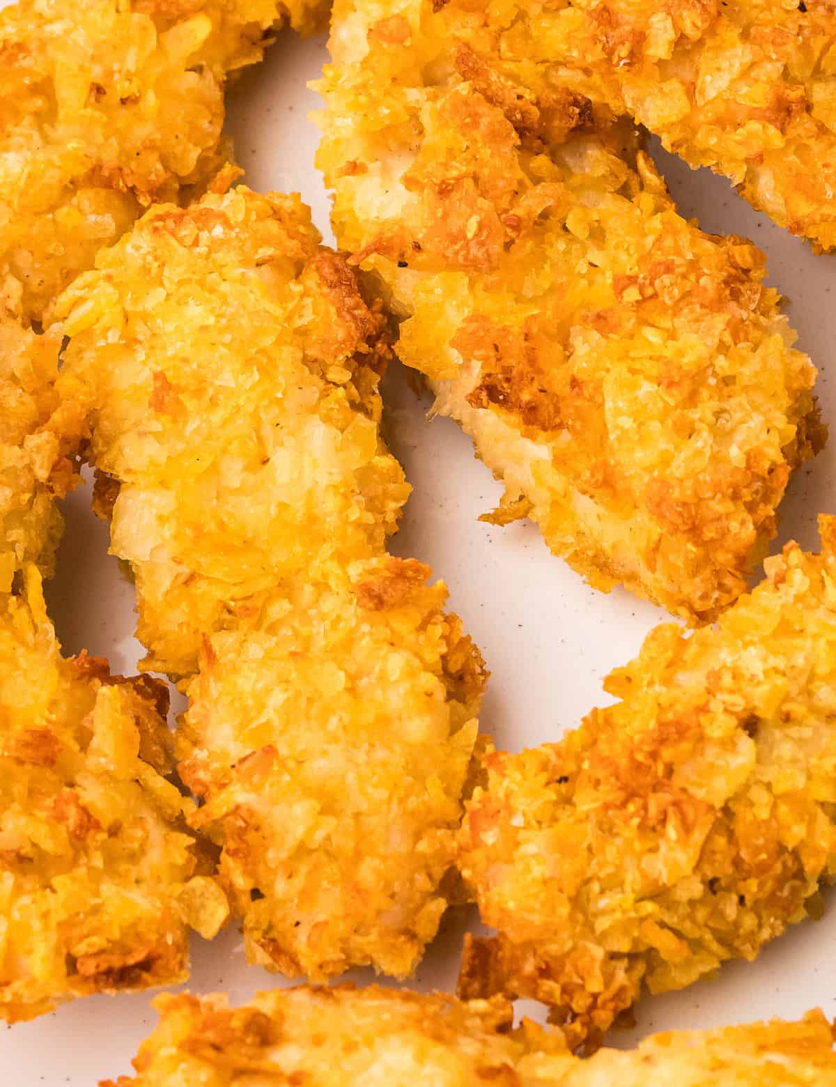 Fresh chicken tenders are dipped in a seasoned egg mixture, then coated in salty crushed potato chips. These crusted chicken tenders are absolutely amazing, and so easy to make in the air fryer or oven!