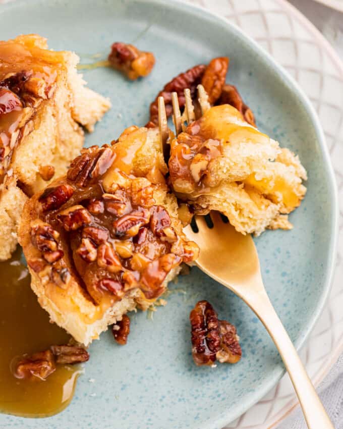 forkful of stick buns on blue plate