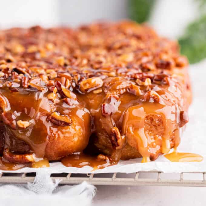 view of the side of sticky buns with caramel dripping over the top