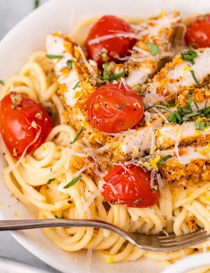 white bowl of lemon chicken pasta with tomatoes