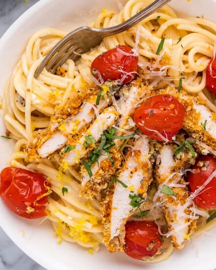 This creamy lemon chicken pasta combines bright and tangy creamy pasta, crunchy baked chicken cutlets, garlicky burst cherry tomatoes, and savory Parmesan cheese. It's a great weeknight-friendly dinner idea that the whole family will love!