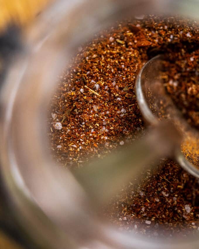 close up view of taco seasoning mix in spice jar with spoon