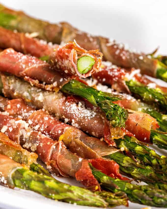 prosciutto wrapped asparagus spear with a bite taken out of it