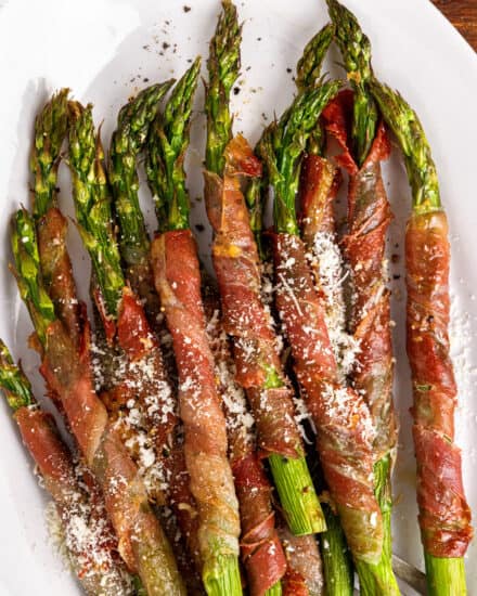 This easy recipe for Prosciutto-Wrapped Asparagus is made with 4 basic ingredients, with an optional Parmesan cheese sprinkle. Made simply in the air fryer, oven, or on the grill, they're cooked until the prosciutto is crispy and the asparagus is perfectly tender. Easiest side dish ever!