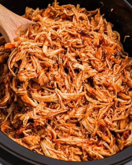 Perfect for a crowd, this slow cooker bbq chicken is made with just 3 simple ingredients! The shredded meat is great piled on a bun, used in quesadillas, salads, pizzas, and more!