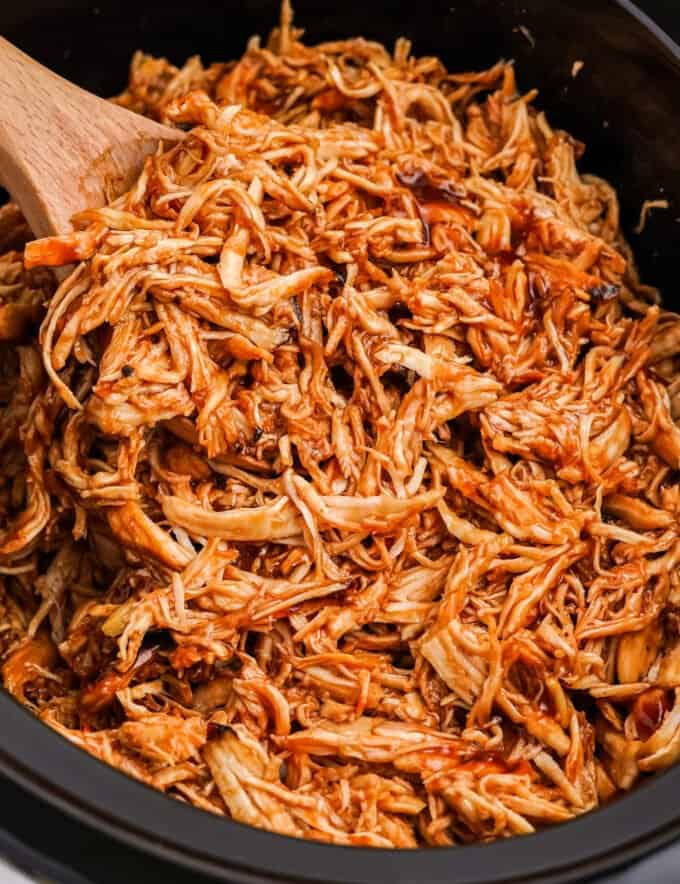 Perfect for a crowd, this slow cooker bbq chicken is made with just 3 simple ingredients! The shredded meat is great piled on a bun, used in quesadillas, salads, pizzas, and more!