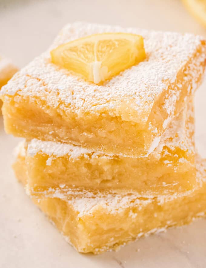 This is the ultimate in refreshing and light desserts… creamy lemon squares made all from scratch with a buttery shortbread crust, and tangy and bright lemon filling!  So foolproof… anyone can make these lemon bars!