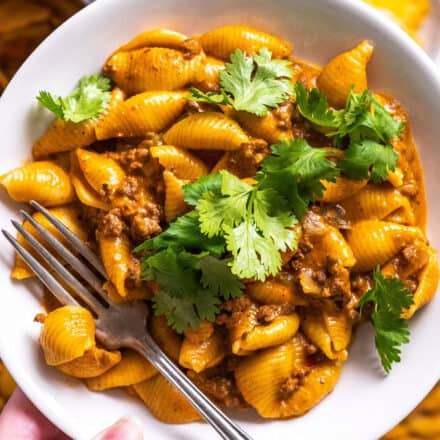 white bowl of taco pasta with cilantro