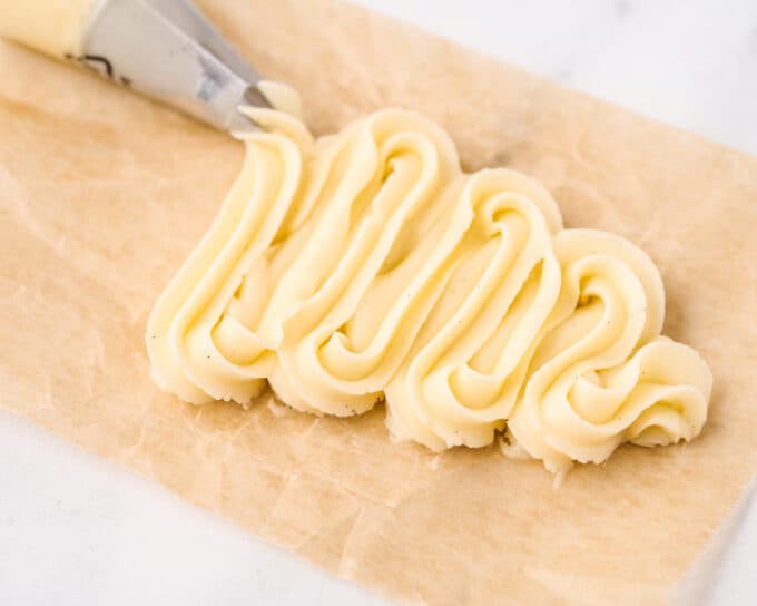 back and forth swirls of frosting on parchment paper