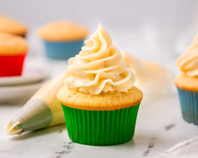 decorating a vanilla cupcake