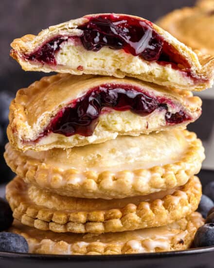 These Blueberry Cheesecake Hand Pies are an easy-to-make, portable dessert - mini pockets of silky cheesecake and sweet blueberry pie filling! This recipe uses a lot of store-bought ingredients to eliminate a lot of the hassle and make this a perfect dessert for beginners, and is made easily in the air fryer (oven instructions are also included).