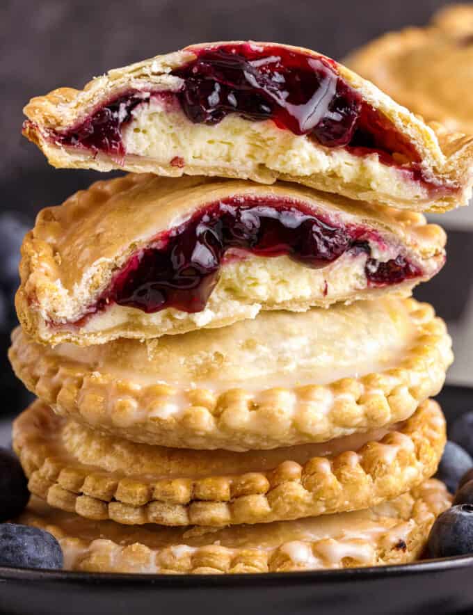 These Blueberry Cheesecake Hand Pies are an easy-to-make, portable dessert - mini pockets of silky cheesecake and sweet blueberry pie filling! This recipe uses a lot of store-bought ingredients to eliminate a lot of the hassle and make this a perfect dessert for beginners, and is made easily in the air fryer (oven instructions are also included).