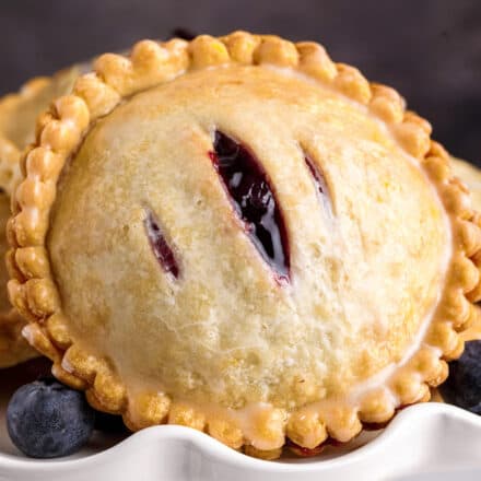 closeup of a blueberry cheesecake hand pie with 3 small slits cut in the top