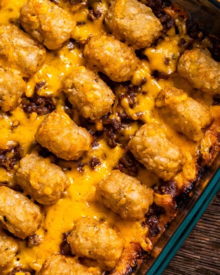 This sloppy joe casserole is a hearty freezer-friendly dinner for the whole family! A rich and saucy homemade sloppy joe layer is topped with cheddar cheese and crispy tater tots, and baked until bubbly and hot. Perfect for a busy weeknight or casual weekend supper!