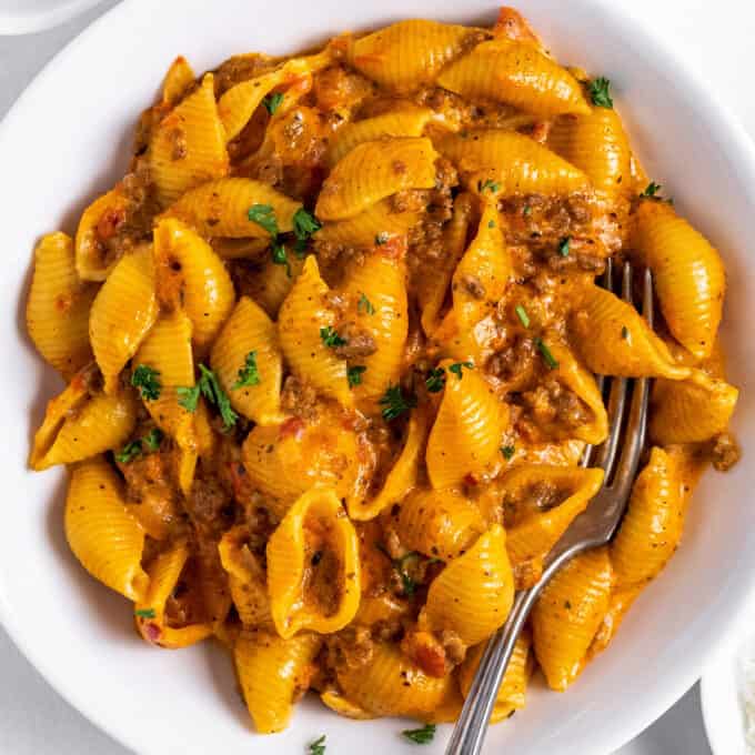 creamy beef and shells in white bowl